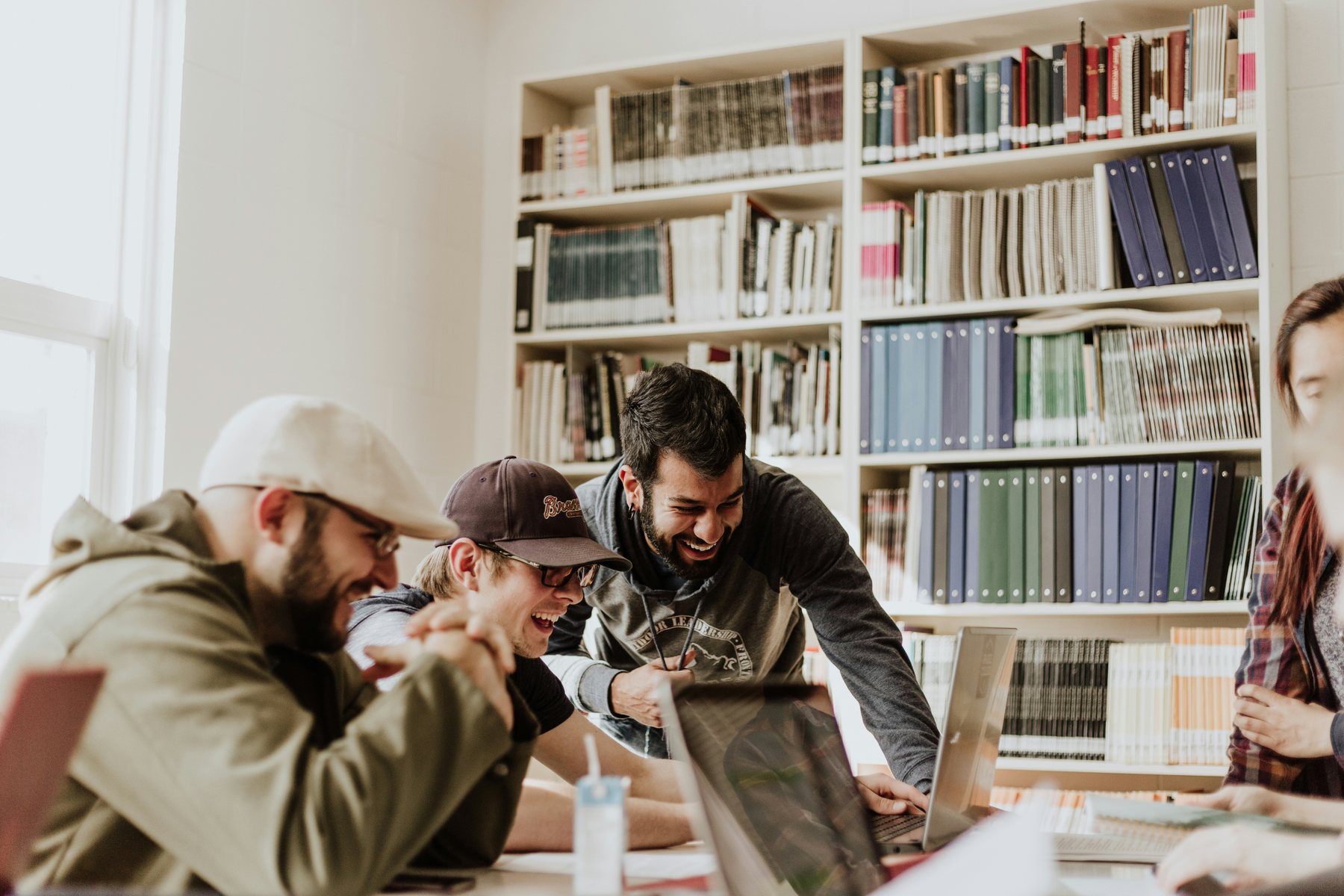 People sharing notes and learning together at a library table