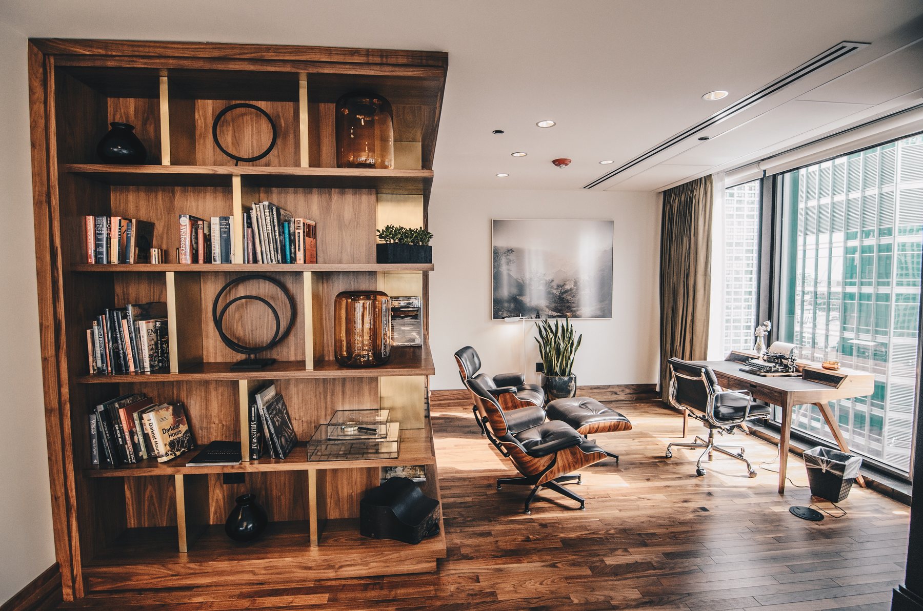 Wooden bookshelves and reading chairs in a sunlit room